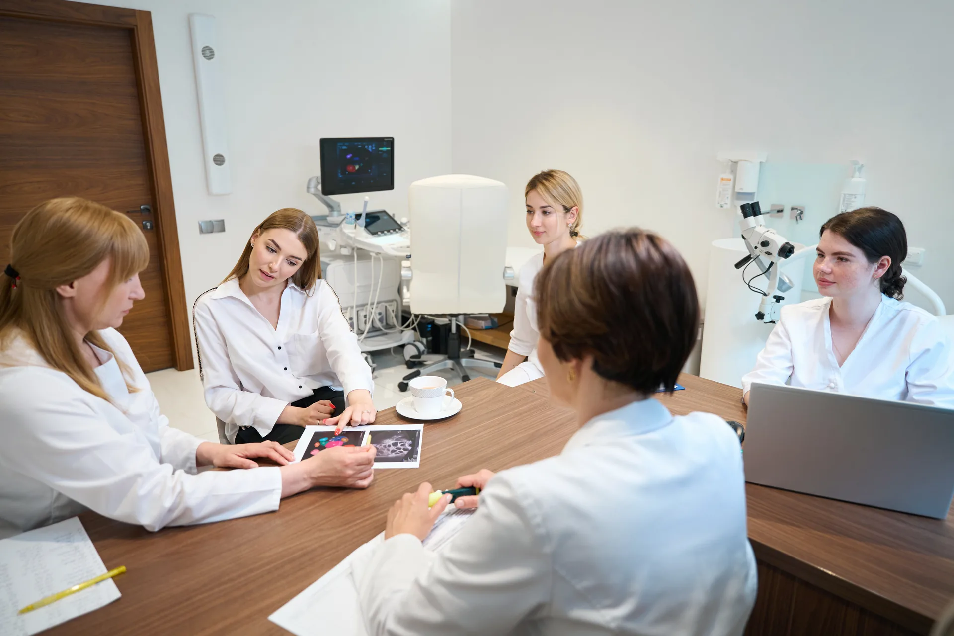 Sycamore dermatology providers reviewing patient images together in a clinical consultation room